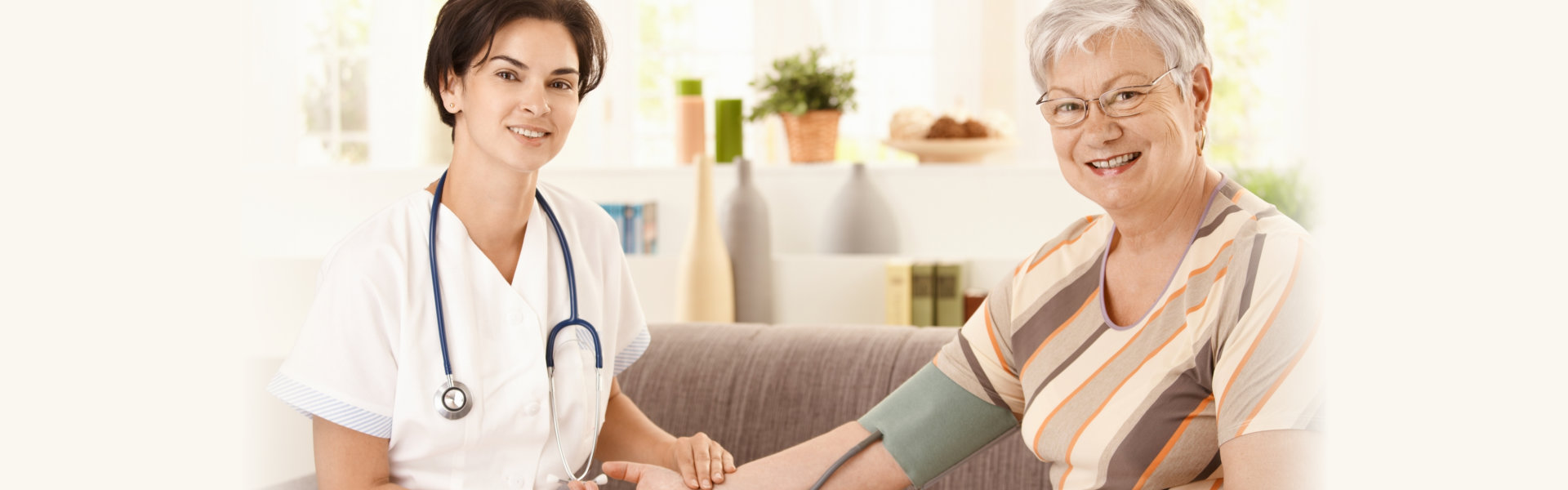 Nurse measuring blood pressure of senior woman